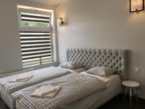a bedroom with two beds and a window at Panorama Gdynia Rooms in Gdynia