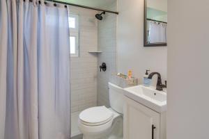 a white bathroom with a toilet and a sink at Sunny Cloquet Home - 2 Mi to St Louis River! in Cloquet +23 photos