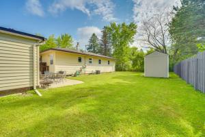 a yard with a white shed next to a house at Sunny Cloquet Home - 2 Mi to St Louis River! in Cloquet