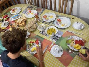 a person sitting at a table with eggs and food at Kandy Nest Stay Home in Kandy