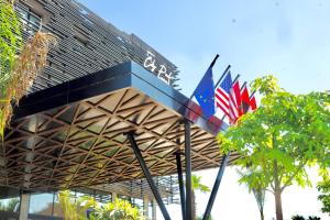 two australian flags hanging from a building at City Park Hôtel in Casablanca