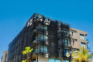 a tall black building with a sign on it at City Park Hôtel in Casablanca