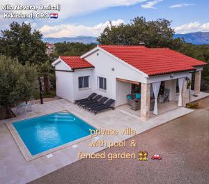 a villa with a pool and a house at Villa Nevera in Omišalj