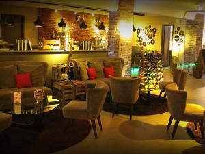 a living room with a couch and chairs and a table at Hotel Volksschule in Hamburg
