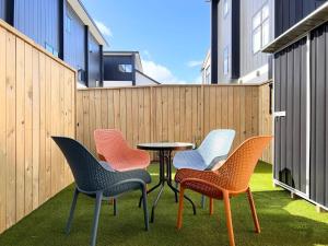 a group of chairs and a table on a patio at New 3 Storey luxe townhouse on quiet street in Christchurch