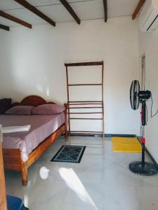 a bedroom with a bed and a fan at Relax garden in Sigiriya +12 photos