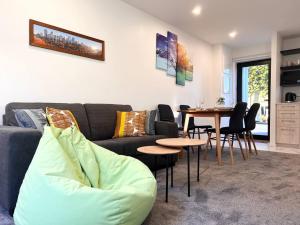 una sala de estar con un sofá y una mesa en Premium Location 2beds2bath on Madras, en Christchurch