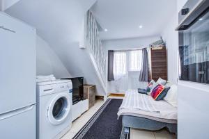 a small laundry room with a washer and dryer at Cosy one bedroom flat in London in London