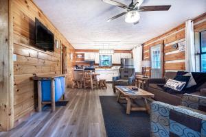 a living room with a couch and a table at Dogwood's Smoky Mtn Cabin Hot Tub And Views in Sevierville