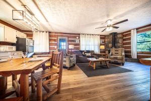 a kitchen and living room with a table and a couch at Dogwood's Smoky Mtn Cabin Hot Tub And Views in Sevierville