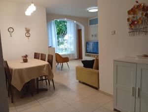 a kitchen and living room with a table and a couch at בין העצים in Petaẖ Tiqwa