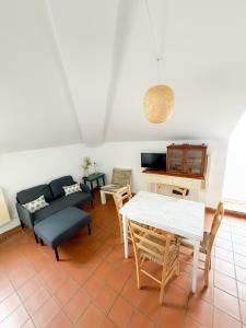 a living room with a couch and a table at Casa das Ancoras Historic Beach Guesthouse in Buarcos Portugal in Bicas