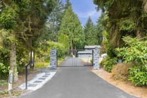 a walkway in a park with trees at Garden Suite Two Bedroom with Hot Tub Sauna Outdoor kitchen and Game Room in Everett
