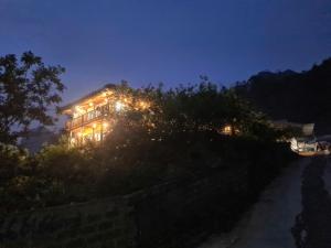 a house lit up at night with lights at Homestay Mộc Bản in Hữu Lũng