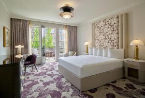 a bedroom with a large white bed and a balcony at Royal Park Hotel in Rochester +76 photos