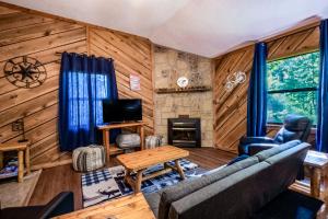 a living room with a couch and a fireplace at Couples Getaway Hot Tub & Mountain View in Sevierville