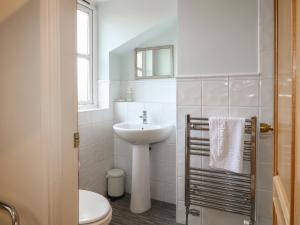 a white bathroom with a sink and a toilet at Hambleton House in Derby +55 photos