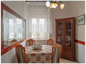 a dining room with a table and chairs and a window at Villa Royal in Cetinje