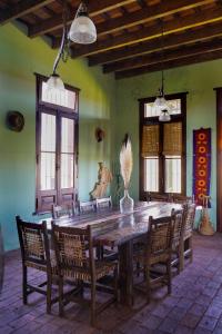 a dining room with a wooden table and chairs at La Negrita Casa de Campo in Azcuénaga