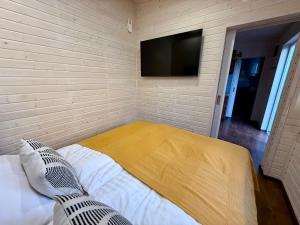a bedroom with a bed and a flat screen tv at Apartmán My dva a terasa in Valtice