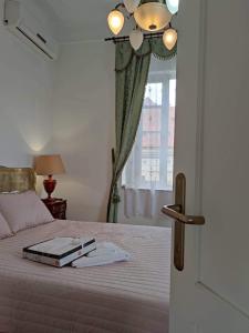 a bedroom with a bed with a book on it at Villa Royal in Cetinje