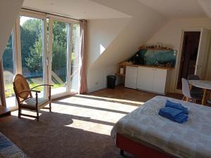 a bedroom with a bed and a large window at tante Pietje Doetinchem in Doetinchem