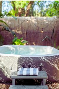 a bath tub with two towels on a table at The Blue Bungalow - Peaceful, Porch, Hot Tub, Downtown in Orlando