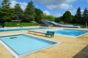 a large swimming pool with a slide in a park at Maison Emeraude - Escapade bistrot chic & nature - Proche Vannes in Sérent