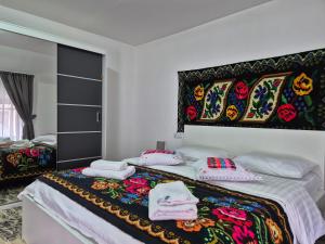 a bedroom with a bed with towels on it at Casa Stefania Breb in Breb