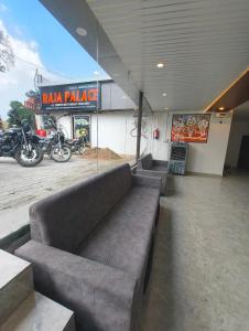 a couch sitting inside of a parking lot with motorcycles at Raja Palace in Ayodhya