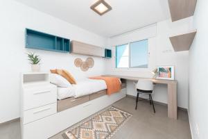 a small bedroom with a bed and a desk at Profithome - Tabaiba Tenerife in Santa Cruz de Tenerife +60 photos
