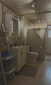a bathroom with a toilet and a sink at Old soul, Sea views in Dhërmi +14 photos
