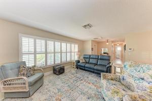 a living room with a couch and a chair at Forget Me Knot in Bradenton +36 photos