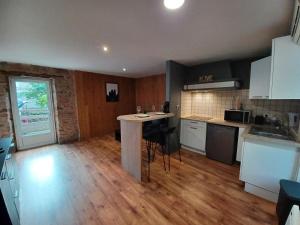 a kitchen with a island in the middle of a room at Appartement T2 Rodez centre in Rodez