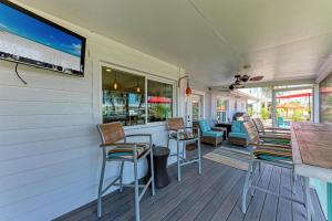 a porch with chairs and a bar on a house at Forget Me Knot in Bradenton