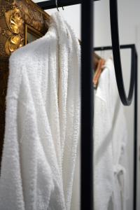 a group of white towels hanging on a rack at W Urban Suites Budapest in Budapest