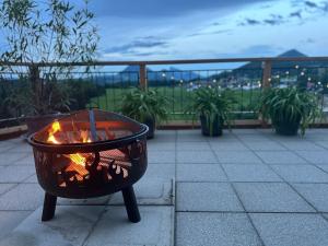 a fire pit sitting on top of a patio at Apartment Postplattler in Hof bei Salzburg