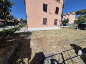 a building with the shadow of a fence in front of it at Angolo Di Michele e Sergio in Foligno