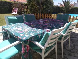 a table and chairs with a table cloth on it at Quinta Do Mar in Colares