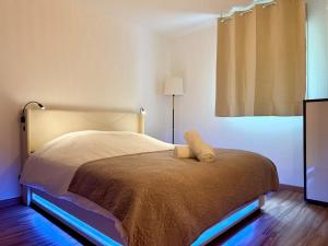 a bedroom with a bed with a teddy bear on it at Le refuge douillet de Colomiers - proche Airbus in Colomiers