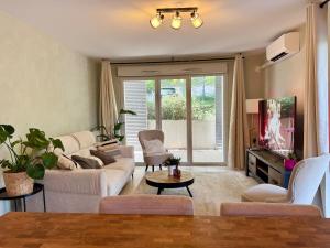 a living room with a couch and a tv at Le refuge douillet de Colomiers - proche Airbus in Colomiers