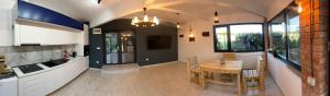 a kitchen with a table and a dining room at Casa Bella in Frăteşti