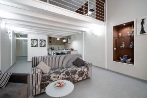 a living room with a couch and a table at Quattro Canti Apartments in Palermo