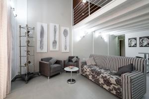 a living room with a couch and a table at Quattro Canti Apartments in Palermo