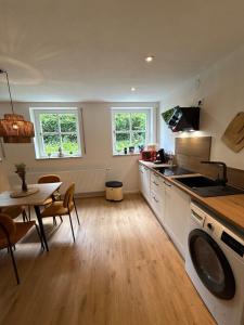 a kitchen and dining room with a table and a stove at Alpspitz Refugium in Nesselwang +20 photos