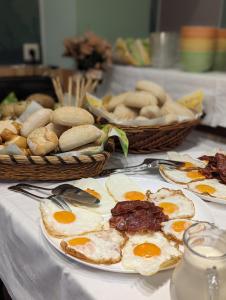 a table topped with plates of eggs and bread at Gästehaus Stein im Thüringer Wald in Rottenbach +14 photos