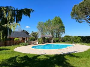 a swimming pool in the middle of a yard at 3 self-contained gites with pool and games room in Saint-Georges-de-Noisné