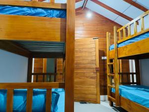 a room with three bunk beds in a room at Mermaid Hostel in Trincomalee