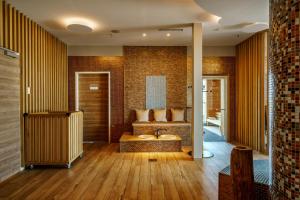 a bathroom with a tub and a sink in it at ScanHotels City in Rostock