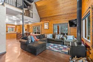 a living room with a couch and a fireplace at Evy's Family Ranch Cabin Secluded in Heber City